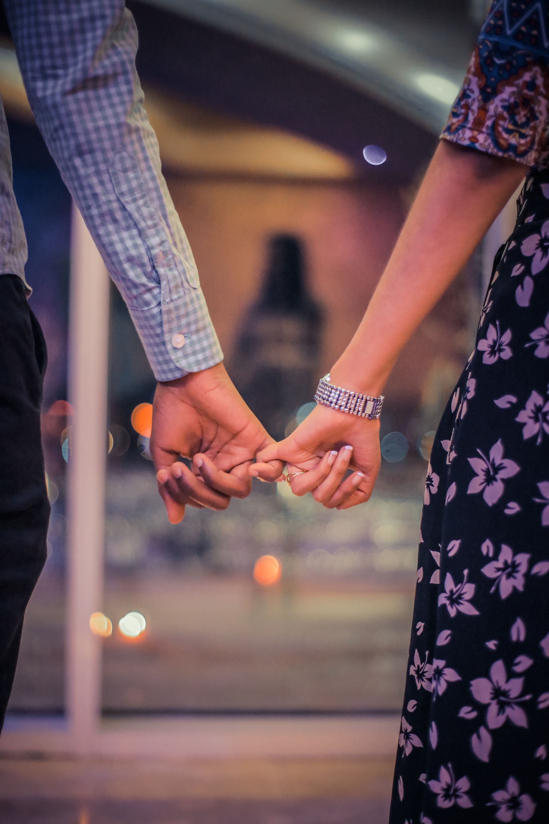 Two people linking their little fingers together