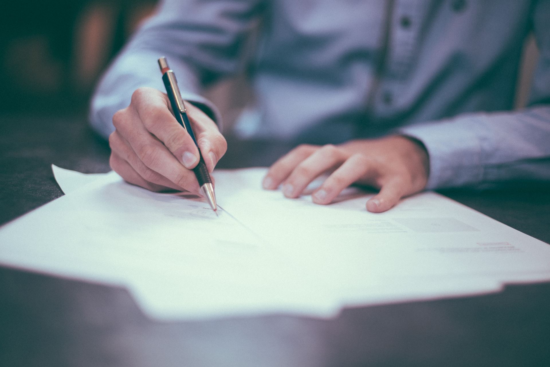 A person writing a letter