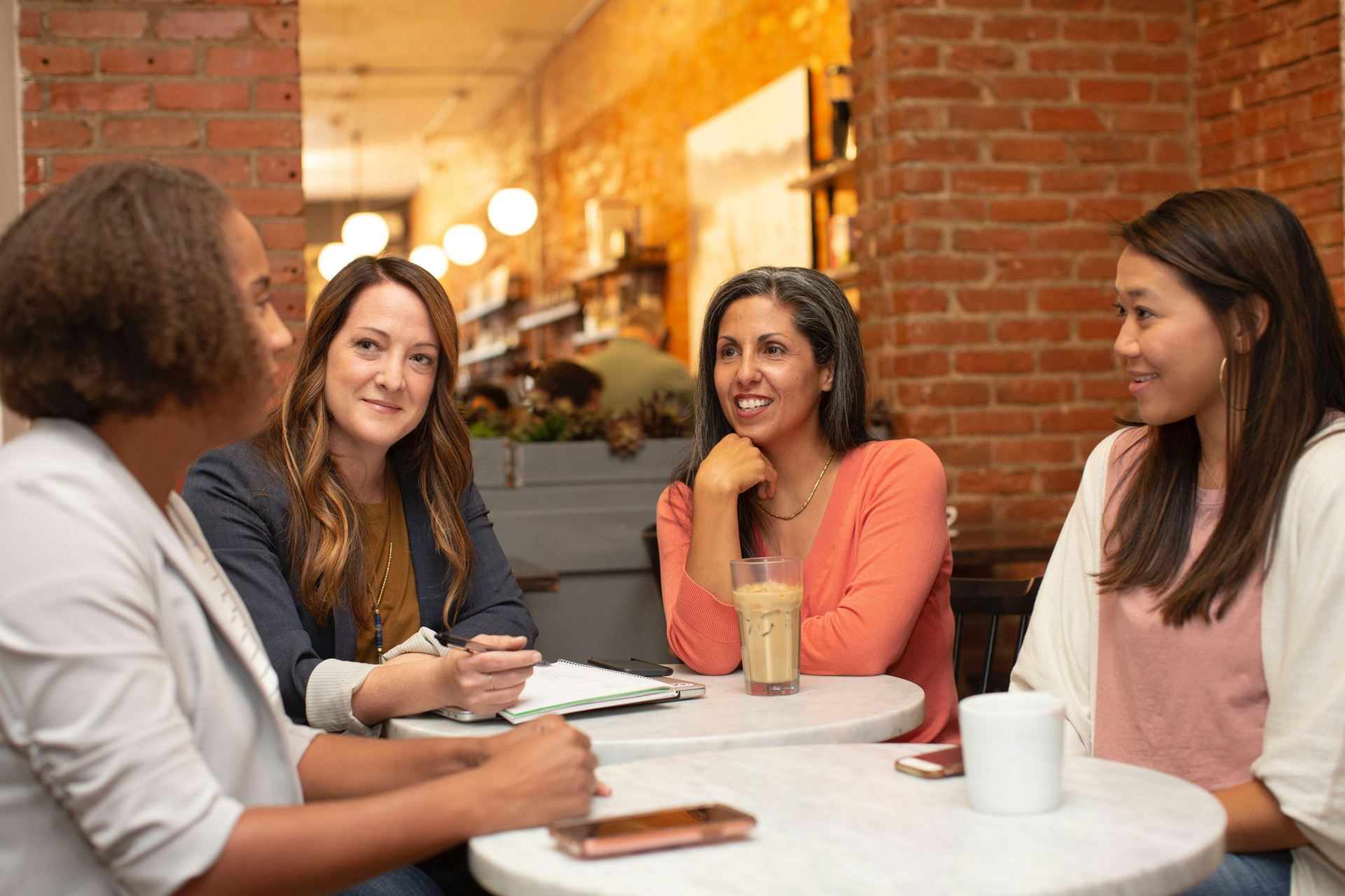 A group of women sitting together in a cafe