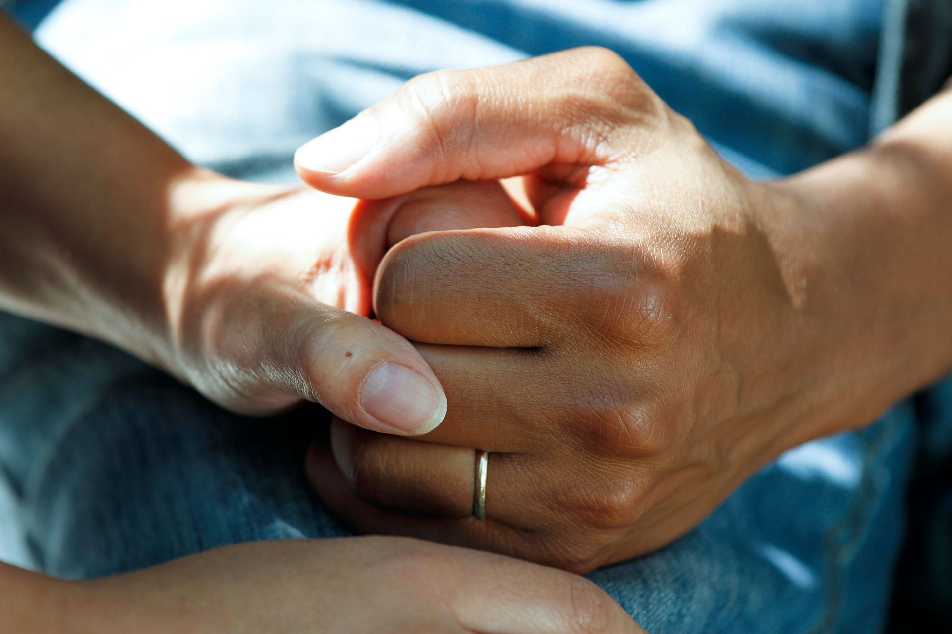 A close-up on someone holding someone else's hand