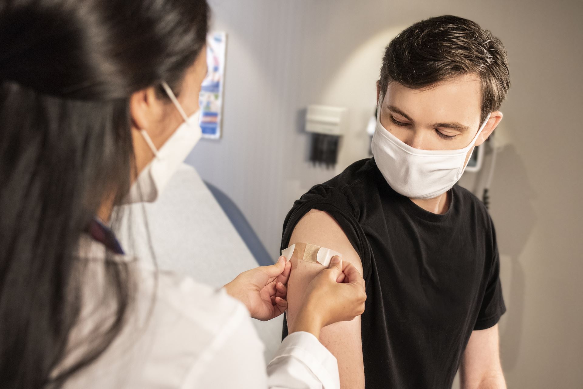 A healthcare professional administering a flu vaccination into a patient's upper arm